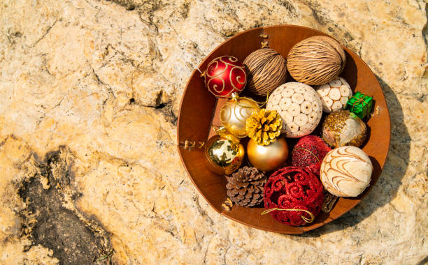 Group of Christmas ball ornament in wooden basket on the rock stock photo