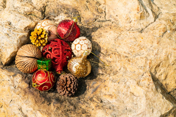 Group of Christmas ball ornament on the rock in sun shine stock photo