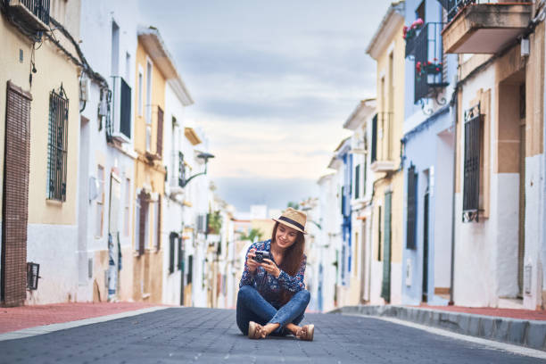 istock Young woman taking photos with old camera 1071024944