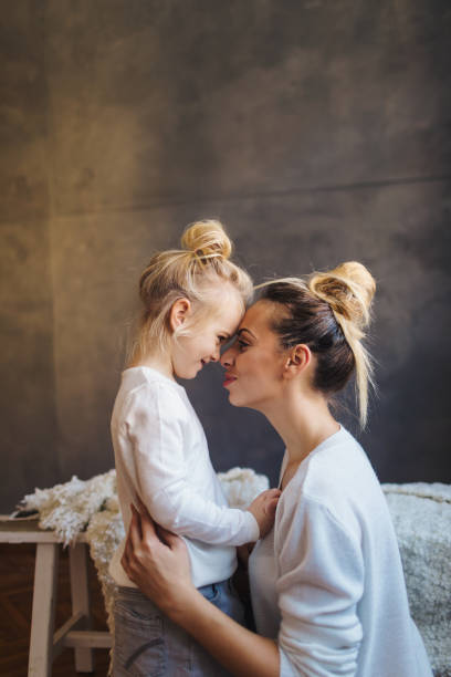 mother daughter moments - clothing love family with one child parent imagens e fotografias de stock