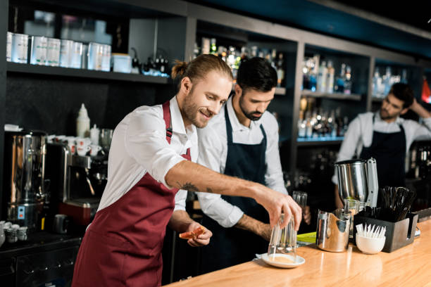 istock smiling barman decorating glass with sugar while holding grapefruit slice 1071027430