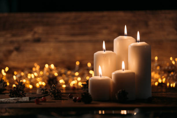 istock Christmas candles on rustic wooden table 1071028172