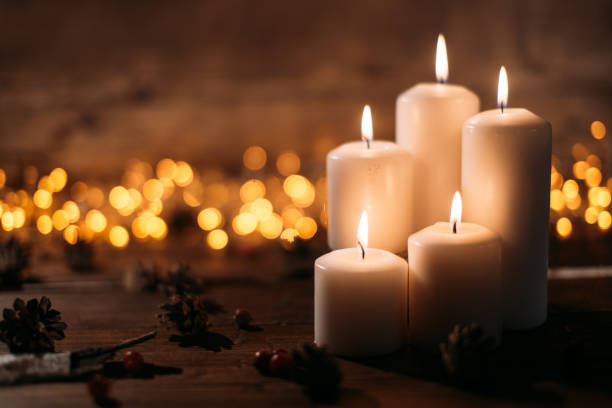 istock Christmas candles on rustic wooden table 1071028272