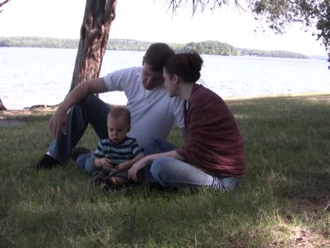 Young family sits at edge of lake PAL