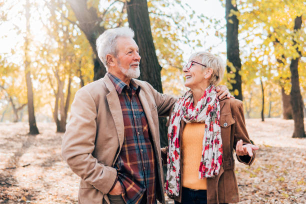 istock Senior couple walking in a park 1071034058