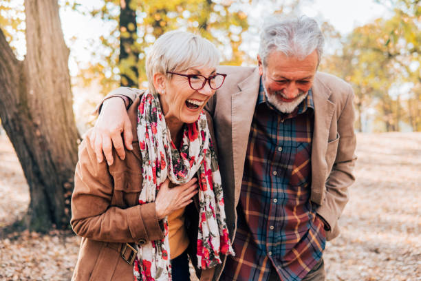 istock Senior couple having a laugh in a park 1071034138