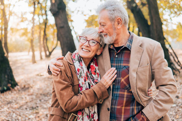 istock Romantic senior couple walking in a park 1071034188