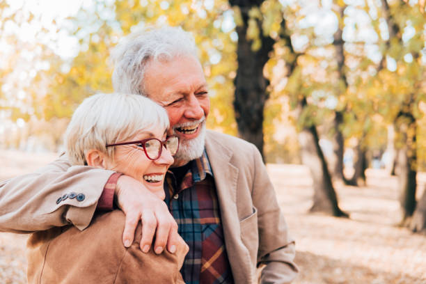 istock Romantic senior couple smiling in a park 1071034556