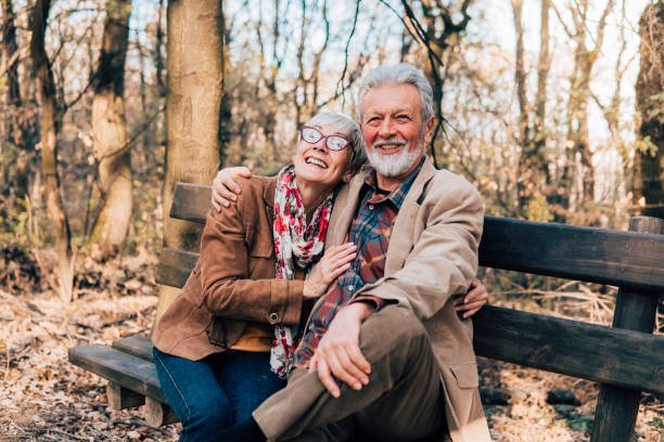 istock Senior couple hugging on a bench in a park 1071036250