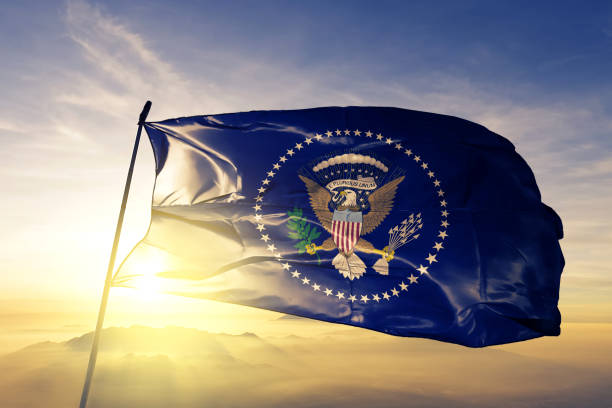 President of the United States flag textile cloth fabric waving on the top sunrise mist fog President of the United States flag on flagpole textile cloth fabric waving on the top sunrise mist fog us president stock pictures, royalty-free photos & images