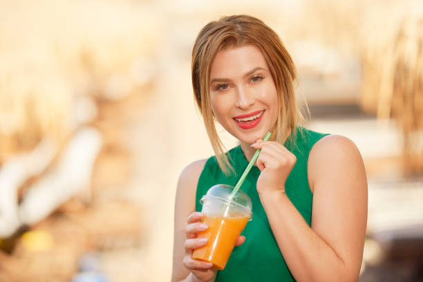 istock drinking delicious orange juice 1071042764