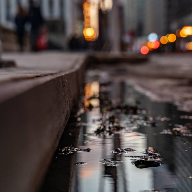 istock Bokeh City Street with Puddle Reflection 1071044256