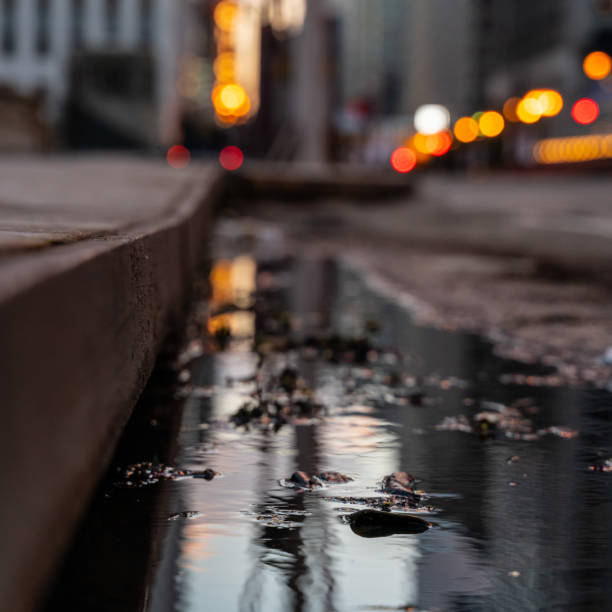 istock Bokeh City Street with Puddle Reflection 1071044264
