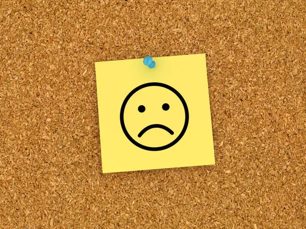 Sticky Note on Corkboard with Sad Emoticon - 3D Rendering