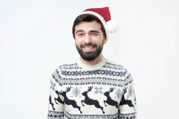 istock Religious cheerful hispanic male in red christmas hat with happy expression 1071046652