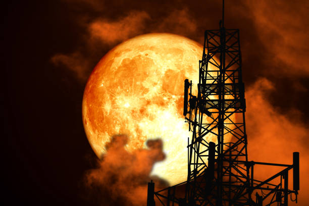istock super blood moon back silhouette Antenna and night cloud on sky 1071048496