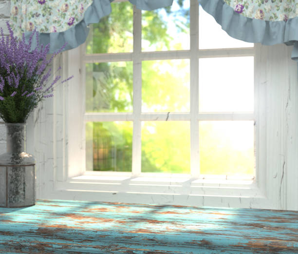 a wooden table top with a blue color and vase of lavender in front of blurred background. - window sill imagens e fotografias de stock