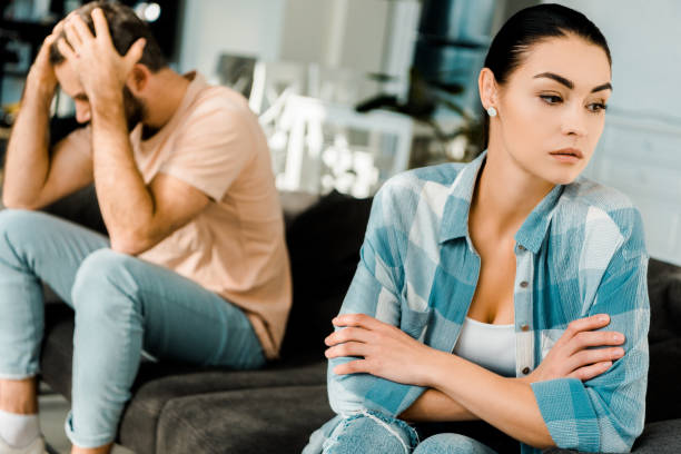 istock upset couple sitting on couch after arguing at home 1071051942
