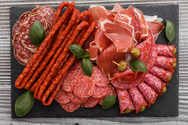 istock Cold smoked meat plate on a rustic wooden background 1071052064