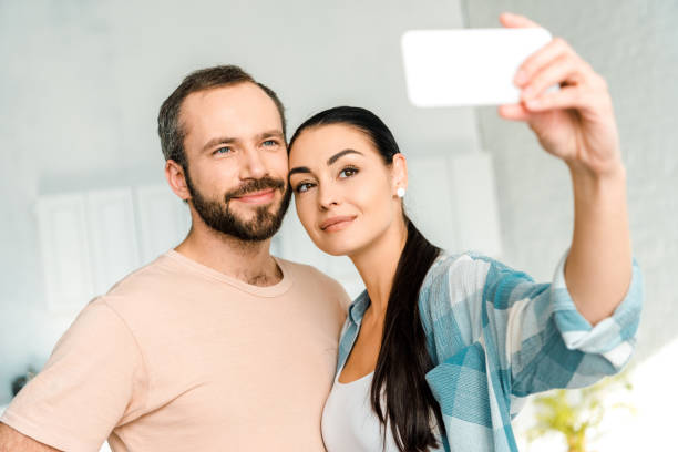 istock loving couple taking selfie on smartphone 1071052146