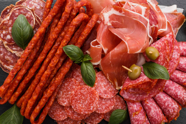 istock Cold smoked meat plate on a rustic wooden background 1071052574