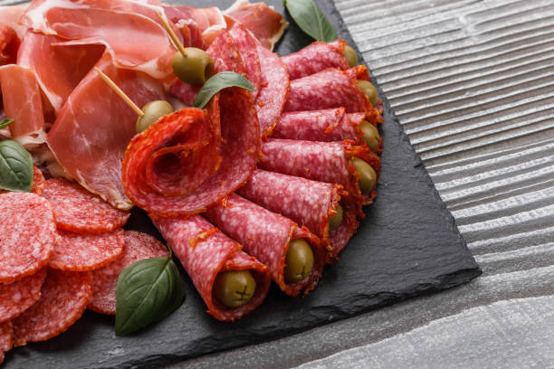 istock Cold smoked meat plate on a rustic wooden background 1071052788