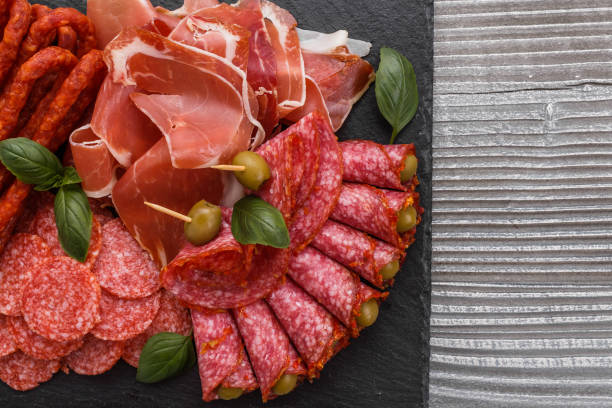 istock Cold smoked meat plate on a rustic wooden background 1071052856
