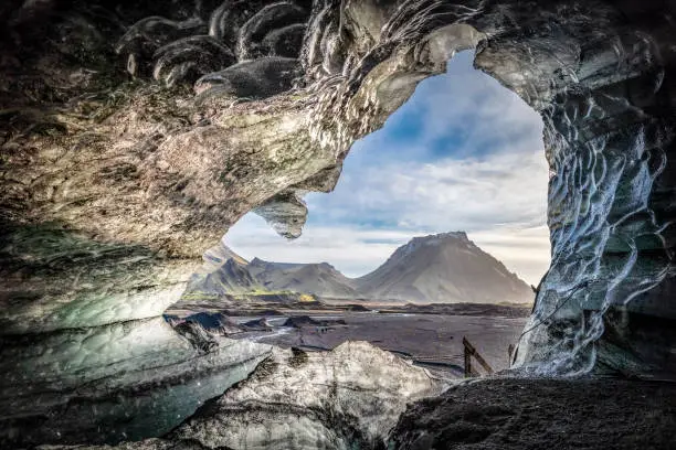 View of ice cave in Kotlujokull glacier in Iceland. Image is representing beautiful nature. The mountain Hafursey can be seen in the background.