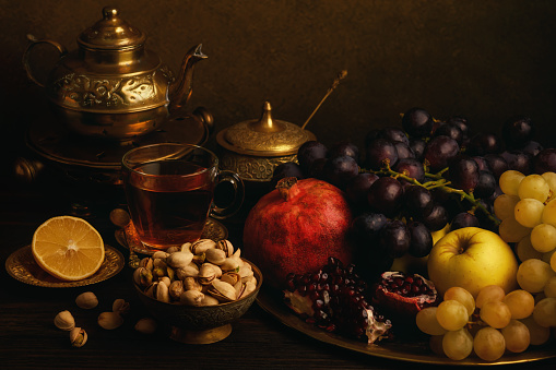Still life with fruits and metal dishes.