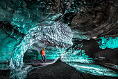 Man exploring ice cave.