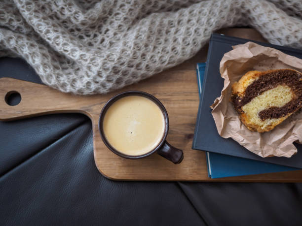 Coffee break - coffee and cake on a leather sofa