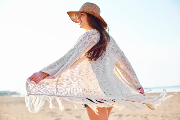 istock Beautiful young woman in straw hat on the beach 1071054876