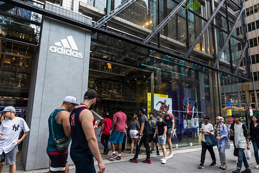 New York City, USA - July 28, 2018: Adidas, sports goods store, in Fifth Avenue (5th Avenue) with people around in Manhattan in New York City, USA
