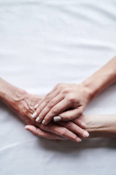 I'm always here for you, never forget that Cropped shot of a young woman holding a senior woman’s hands never stock pictures, royalty-free photos & images