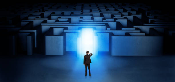 istock Lost businessman standing at illuminated labyrinth entrance 1071066886