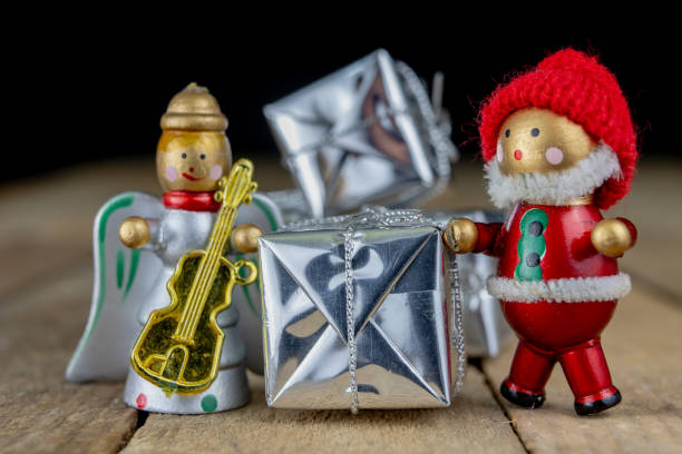 istock Christmas decorations on the kitchen table. Wooden Christmas figurines prepared for decorating a tree. Dark background. 1071067064