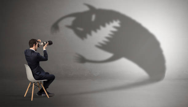 istock Businessman negotiate with a monster shadow 1071068496