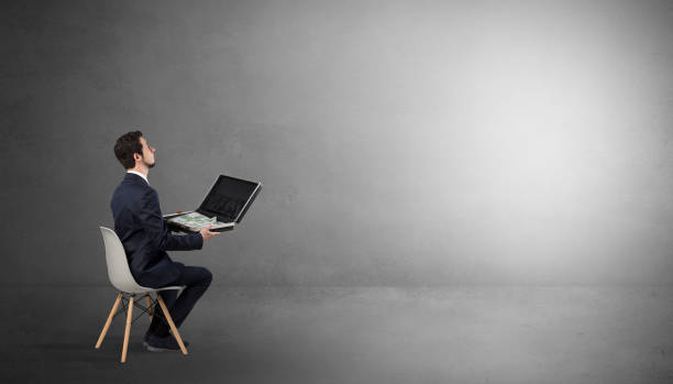 istock Businessman staying in an empty room with stuffs on his lap 1071068580