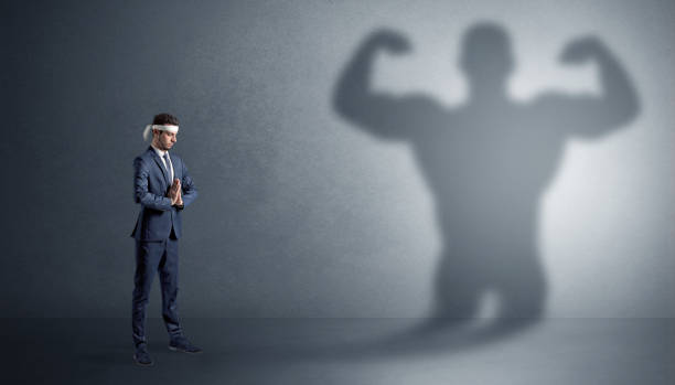 istock Karate man fighting with a big scary shadow 1071068846