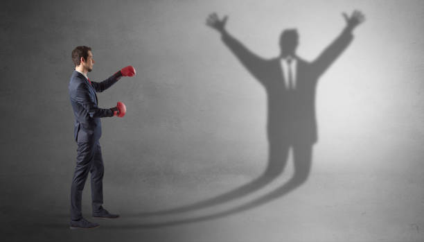 istock Businessman fighting with a disarmed businessman shadow 1071068984