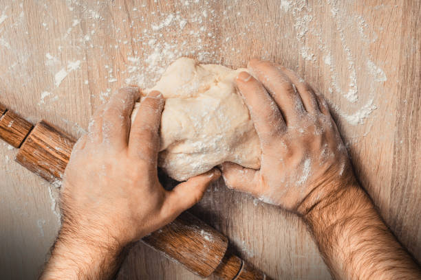 istock male chef kneads the dough 1071069022