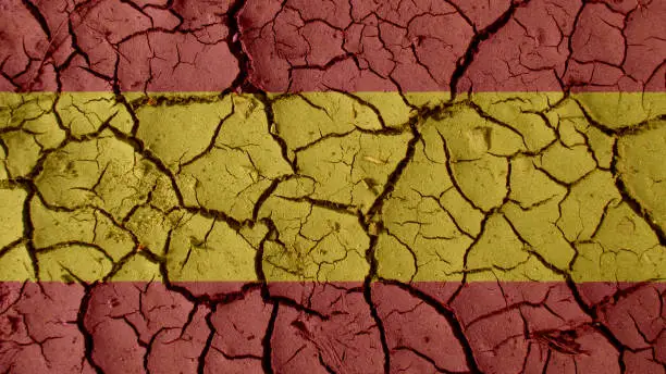 Political Crisis Or Environmental Concept: Mud Cracks With Spain Flag