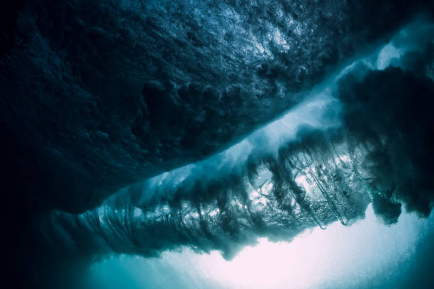 istock Underwater wave. Blue barrel wave crashing in ocean. 1071069588