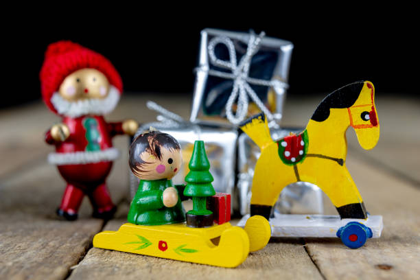 istock Christmas decorations on the kitchen table. Wooden Christmas figurines prepared for decorating a tree. Dark background. 1071069808