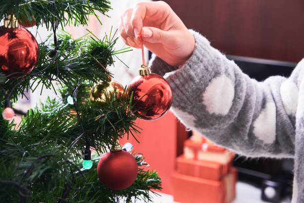 istock Woman decorating Christmas tree 1071070118