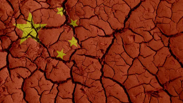 Political Crisis Or Environmental Concept: Mud Cracks With China Flag