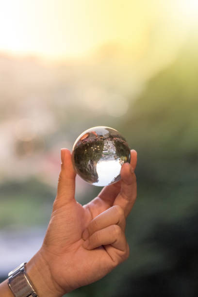 istock Holding crystal ball with bokeh sunset background 1071071174