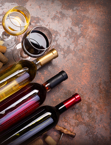wine bottles and glass on table with copy space, background