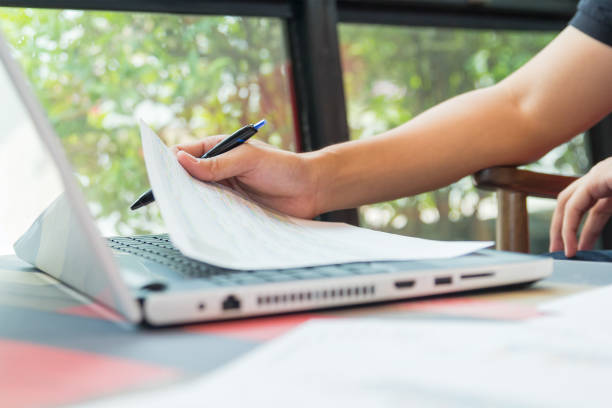 istock Businessman working by laptop with tablet and smartphone and document on desk 1071076132