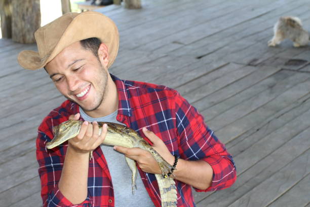istock Ethnic man holding baby caiman 1071078674